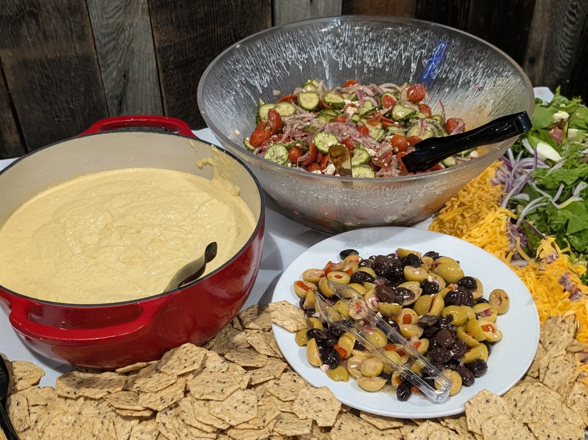 Roasted red pepper hummus, Greek tomato-cucumber-feta salad, and a Castelvetrano-black olive medley with seeded gluten-free crackers