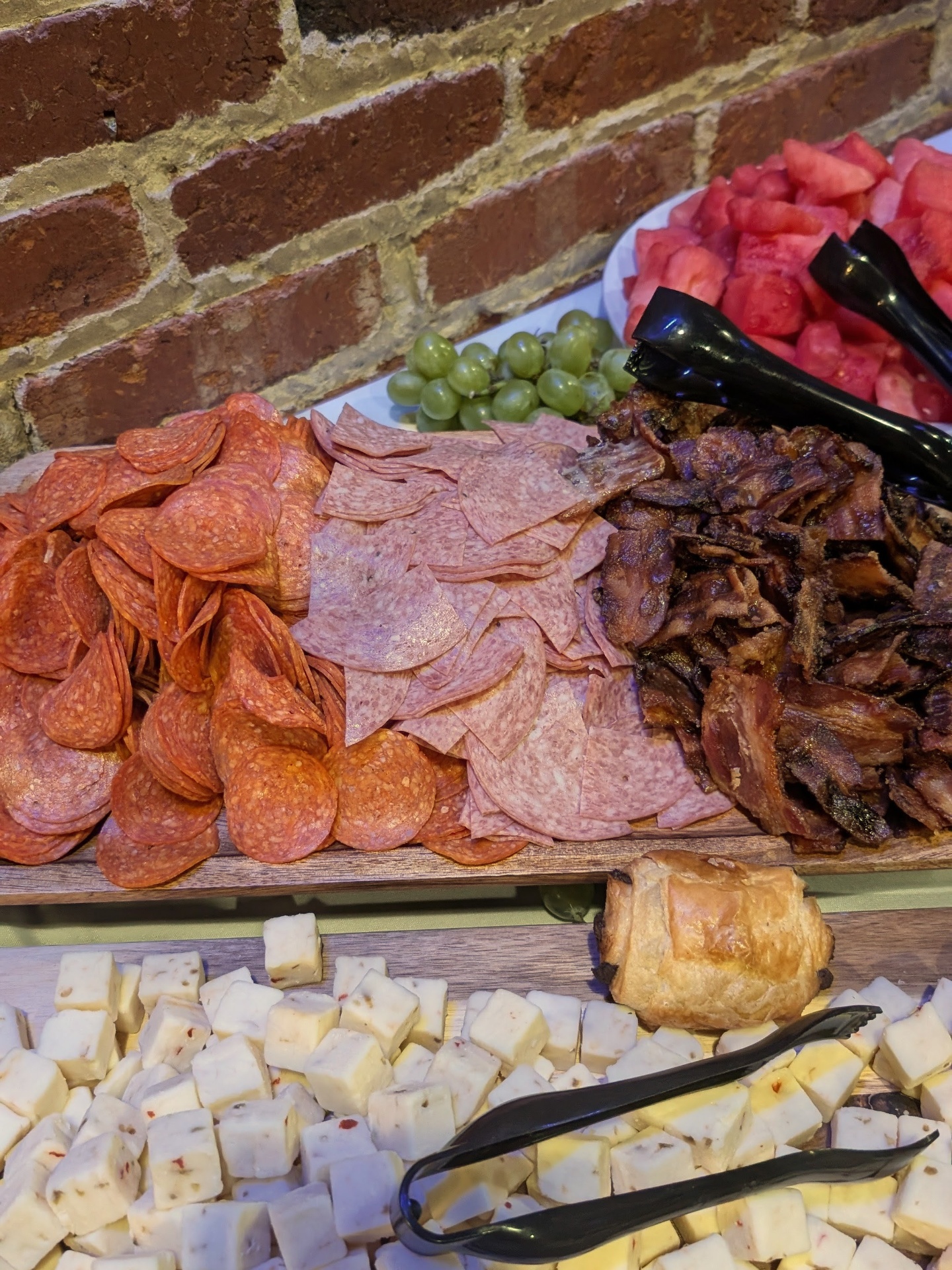 Close-up of the cured meats board with pepperoni, salami, and smoked brisket